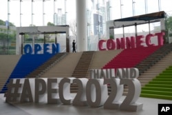 An officer walks near signs of Asia-Pacific Economic Cooperation (APEC) in Bangkok, Thailand, Nov. 14, 2022.