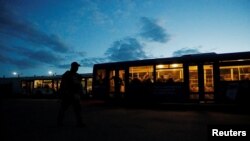 FILE - Service members of Ukrainian forces who have surrendered after weeks holed up at Azovstal steel works are seen inside a bus, which arrived under escort of the pro-Russian military, at a detention facility in the Donetsk Region, Ukraine, May 17, 2022. 