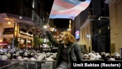 A demonstrator waves a flag during a protest against gender-based violence on the International Day for the Elimination of Violence Against Women, in Istanbul, Turkey November 25, 2021. (Umit Bektas/Reuters)