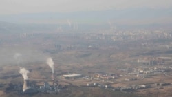 Smoke and steam rise from towers at a coal-fired power plant in Xinjiang, April 21, 2021. (AP/Mark Schiefelbein)