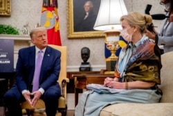 FILE - President Donald Trump speaks during a meeting as White House coronavirus response coordinator Dr. Deborah Birx looks on, in the Oval Office of the White House in Washington, Aug. 5, 2020.