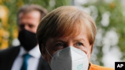 German Chancellor Angela Merkel arrives about a news conference German Government's corona policy in Berlin, Germany, Nov. 2, 2020.