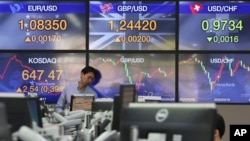 A currency trader watches monitors at the foreign exchange dealing room of the KEB Hana Bank headquarters in Seoul, South Korea, Wednesday, April 29, 2020. Asian stock markets gained Wednesday after France and Spain joined governments that plan to…