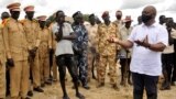 FILE - Alain Noudehou, UN Humanitarian Coordinator in South Sudan, addresses members of his delegation as they visit civilians displaced by flood water caused by broken dykes on the Nile river, in Duk padiet county of Jonglei State, in South Sudan Sept. 2