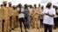 FILE - Alain Noudehou, UN Humanitarian Coordinator in South Sudan, addresses members of his delegation as they visit civilians displaced by flood water caused by broken dykes on the Nile river, in Duk padiet county of Jonglei State, in South Sudan Sept. 2
