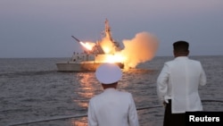 North Korean leader Kim Jong Un oversees a strategic cruise missile test aboard a navy warship