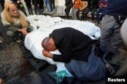 FILE - Mourners react next to the bodies of Palestinians killed in an Israeli strike, amid the ongoing conflict between Israel and the Palestinian Islamist group Hamas, in Rafah in the southern Gaza Strip, January 18, 2024.