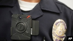 FILE - A Los Angeles police officer is shown wearing an on-body camera during a demonstration for media in Los Angeles. Thousands of police agencies have equipped officers with cameras to wear with their uniforms.