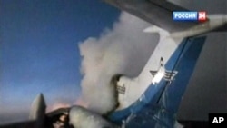 In this image taken from Russia 24 television channel TV, showing a tail part of the Russian passenger Tu-154 aircraft seen after an explosion in Surgut, about 2200 kilometers (1,350 miles) east of Moscow, Russia, 01 Jan 2011