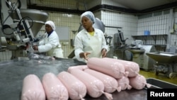 Workers prepare a plant-based polony used as an alternative or meat substitute at meat processor Feinschmecker, in Germiston, in the East Rand region of Johannesburg, South Africa, Oct. 11, 2022.