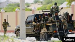 FILE - Somali soldiers are seen riding on a pick-up truck in Mogadishu, Somalia, April 27, 2022. 