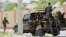 FILE - Somali soldiers are seen riding on a pick-up truck in Mogadishu, Somalia, April 27, 2022. 