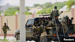 FILE - Somali soldiers are seen riding on a pick-up truck in Mogadishu, Somalia, April 27, 2022. 