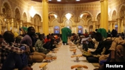 A man prepares food to the faithfuls for the breaking of the Muslim fast during the holy month of Ramadan at "La Grande Mosque Moride" in Dakar
