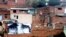 FILE - A picture is seen on the roof of a house in a neighborhood of northeast Medellín, Colombia, Jan. 30, 2012. An art project called "Heroes Without Borders" placed 23 photographs on different facades to prevent recruitment of children by illegal groups.