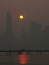 The sun rises over the lower Manhattan skyline as seen from Jersey City, New Jersey, June 8, 2023.&nbsp;Intense Canadian wildfires are blanketing the northeastern U.S. in a dystopian haze, turning the air acrid, the sky yellowish gray and prompting warnings for vulnerable populations to stay inside.