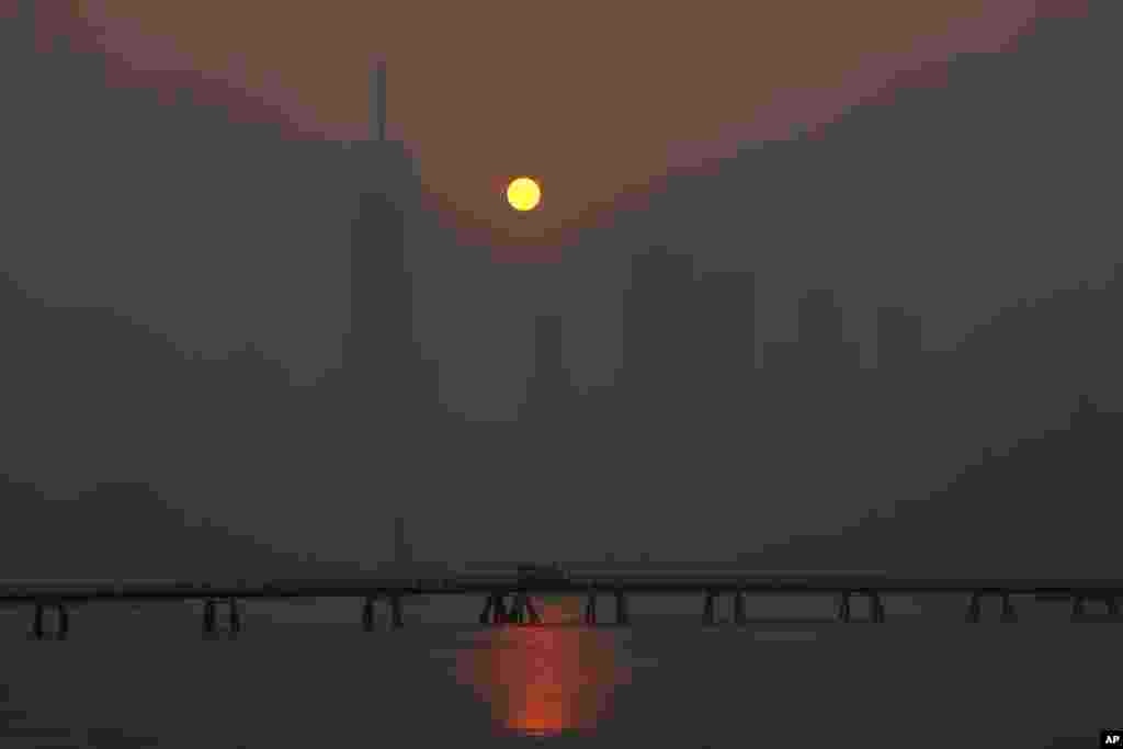 The sun rises over the lower Manhattan skyline as seen from Jersey City, New Jersey, June 8, 2023.&nbsp;Intense Canadian wildfires are blanketing the northeastern U.S. in a dystopian haze, turning the air acrid, the sky yellowish gray and prompting warnings for vulnerable populations to stay inside.