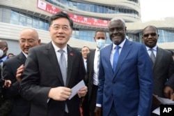 FILE - China's previous foreign minister, Qin Gang, left, and African Union Commission chair Moussa Faki Mahamat, right, attend the inauguration of the Africa Centers for Disease Control and Prevention in Addis Ababa, Ethiopia, on Jan. 11, 2023. China announced July 25, 2023, that it had removed the outspoken Qin Gang from office and replaced him with his predecessor, Wang Yi.