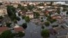 People ride on a rubber boat in a flooded neighborhood in Kherson, Ukraine, June 7, 2023.
