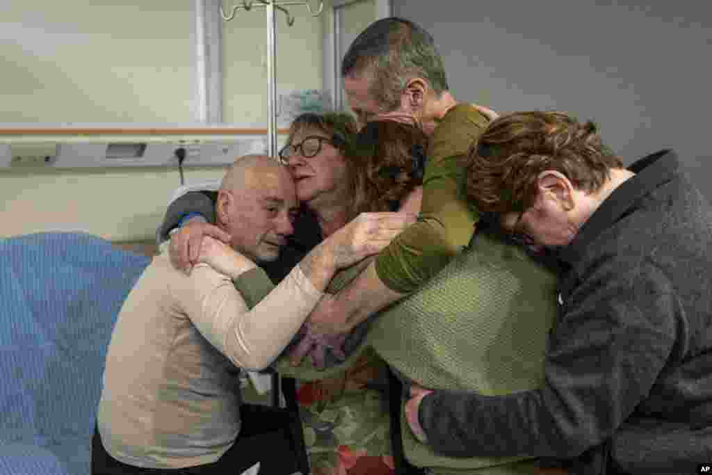 Hostage Luis Har, left, is hugged by relatives after being rescued from captivity in the Gaza Strip, at the Sheba Medical Center in Ramat Gan, Israel.