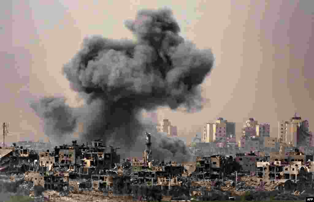 This image taken from the Israeli border with the Gaza Strip shows a black cloud of smoke ascending from the Gaza Strip amid the ongoing battles between Israel and the Palestinian group Hamas.