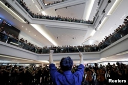 FILE - A group of music performers plays a protest song "Glory to Hong Kong" inside a shopping mall at Kowloon Tong, in Hong Kong, China, Sept. 18, 2019.