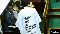 FILE - Member of Parliament from Bubulo contituency John Musira, dressed in an anti-gay gown, attends the debate of the Anti-Homosexuality Act inside the chambers at the Parliament buildings in Kampala, Uganda, March 21, 2023.