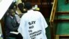 FILE - Member of Parliament from Bubulo contituency John Musira, dressed in an anti-gay gown, attends the debate of the Anti-Homosexuality Act inside the chambers at the Parliament buildings in Kampala, Uganda, March 21, 2023. 