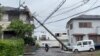 A person rides through a fallen pole following Typhoon Shanshan in Miyazaki, Japan, Aug. 29, 2024 in this screengrab taken from a social media video. 