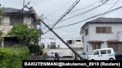 A person rides through a fallen pole following Typhoon Shanshan in Miyazaki, Japan, Aug. 29, 2024 in this screengrab taken from a social media video. 