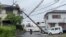 A person rides through a fallen pole following Typhoon Shanshan in Miyazaki, Japan, Aug. 29, 2024 in this screengrab taken from a social media video. 