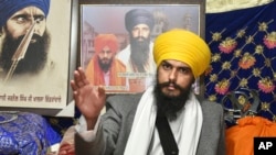 FILE - Sikh separatist leader and head of Waris Punjab De, or Punjab's Heirs, Amritpal Singh, talks to his supporters in the village Jallupur Khera, near Amritsar, India, on Jan.7, 2023.