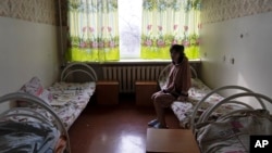 Natalia, 37, a patient, sits in her room at a psychiatric hospital in Kramatorsk, Ukraine, Tuesday March 21, 2023. (AP Photo/Vasilisa Stepanenko)