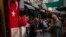 FILE - A vendor does business with a customer in a street market in Istanbul, Turkey, on Sept. 6, 2023. Turkey's central bank delivered another huge interest rate hike on Nov. 23, 2023, which has left households struggling to afford food and other basic goods