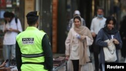 An Iranian police force stands on a street during the revival of morality police in Tehran, Iran, July 16, 2023. (Majid Asgaripour/WANA via Reuters)