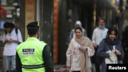 An Iranian police force stands on a street during the revival of morality police in Tehran, Iran, July 16, 2023. (Majid Asgaripour/WANA via Reuters)