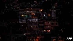 FILE - Partial view of the neighborhood Petare hill, March 10, 2019, during a massive power outage which has left Caracas and much of the country without communications, water and electricity.