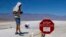People cover themselves in white towels as they walk around Badwater Basin in Death Valley National Park, California, July 7, 2024. Forecasters say a heat wave could break previous records across the U.S. 