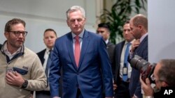 Speaker of the House Kevin McCarthy of California emerges from a closed-door Republican strategy session to talk to reporters about updates on funding the government and averting a shutdown, at the Capitol in Washington, Sept. 27, 2023.