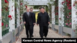 FILE - Russia's President Vladimir Putin and North Korea's leader Kim Jong Un walk in the garden of the Kumsusan Guesthouse in Pyongyang, North Korea in this image released by the Korean Central News Agency, June 20, 2024. (KCNA via Reuters)
