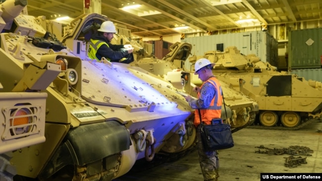 FILE - Soldiers prepare a Bradley Fighting Vehicle for overseas transport Jan. 25, 2023, in North Charleston, South Carolina. More than 60 Bradleys were shipped as part of a U.S. military aid package to Ukraine.