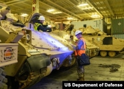 FILE - Soldiers prepare a Bradley Fighting Vehicle for overseas transport on Jan. 25, 2023, in North Charleston, South Carolina. More than 60 Bradleys were shipped as part of a U.S. military aid package to Ukraine.