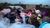 Ethnic Armenians from Nagorno-Karabakh sit in a truck on their way to Kornidzor in Syunik region, Armenia, Sept. 25, 2023. 