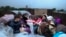 Ethnic Armenians from Nagorno-Karabakh sit in a truck on their way to Kornidzor in Armenia's Syunik region, Sept. 25, 2023. 