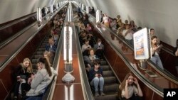 FILE: People take cover at a metro station during a Russian rocket attack in Kyiv, Ukraine, May 29, 2023.