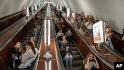 People take cover at a metro station during a Russian rocket attack in Kyiv, Ukraine, May 29, 2023. 