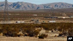 FILE - This Jan. 25, 2012, photo shows the site of a proposed station for a high-speed rail line, with Interstate 15 in the background, on the far outskirts of Victorville, Calif., the Mojave Desert city on the route from Los Angeles to Las Vegas. 