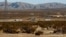 FILE - This Jan. 25, 2012, photo shows the site of a proposed station for a high-speed rail line, with Interstate 15 in the background, on the far outskirts of Victorville, Calif., the Mojave Desert city on the route from Los Angeles to Las Vegas.   