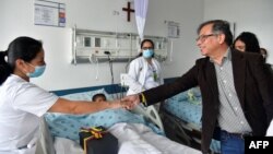 Colombia's President Gustavo Petro greets the doctors attending to the children who survived the crash of a Cessna 206 in thick jungle, June 10, 2023.