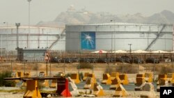 FILE - Storage tanks are seen at the North Jiddah bulk plant, an Aramco oil facility, in Jiddah, Saudi Arabia, March 21, 2021.